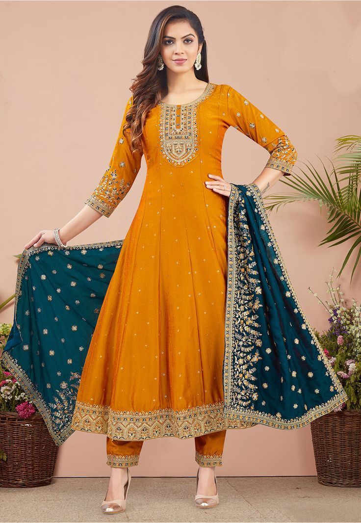Women fashion designer yellow Anarkali suit with embroidered detailing, flared silhouette, and contrasting blue dupatta, perfect for festive and ethnic wear occasions.