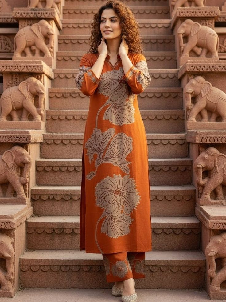 "Elegant orange kurta pant set with large floral prints and contemporary styling, featured in a trendy women casual fashion collection."