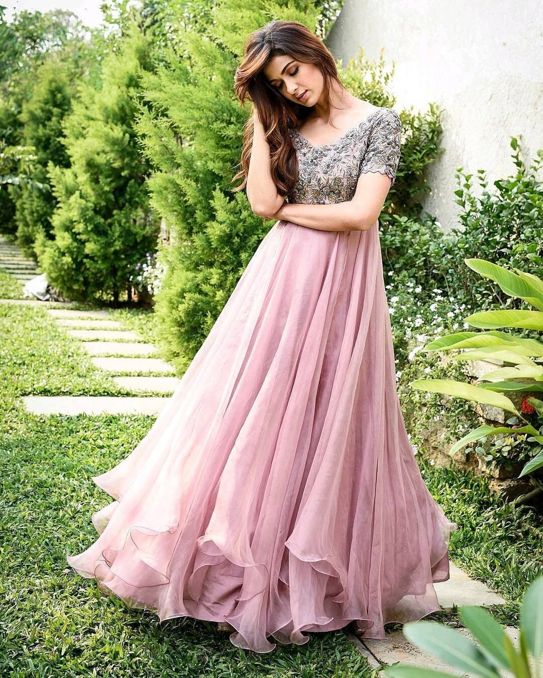 pink evening gown with elegant silver embellished bodice, flowing layered skirt, and graceful party wear styling.